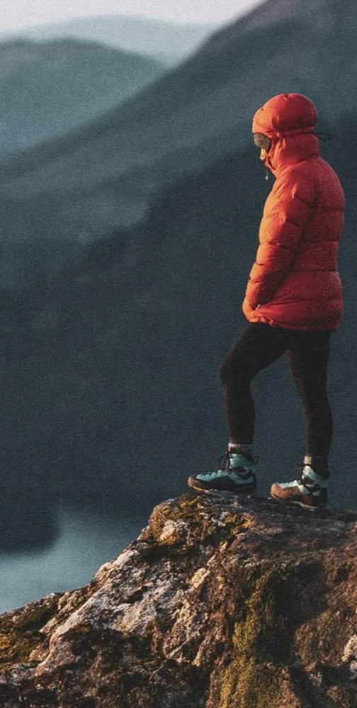 man-red-coat-cliff-edge